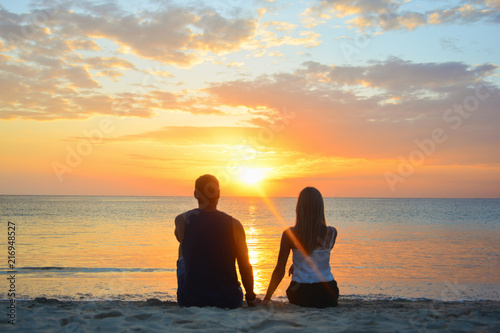 Couple watching the sunset on the beach