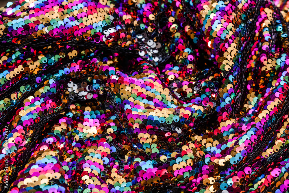 Set of Sequins close-up macro. Abstract background with sequins colorful on the fabric. Texture scales of round sequins 