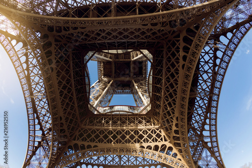Eiffel Tower, view from below, the base of the tower close up, the concept of travel and romance