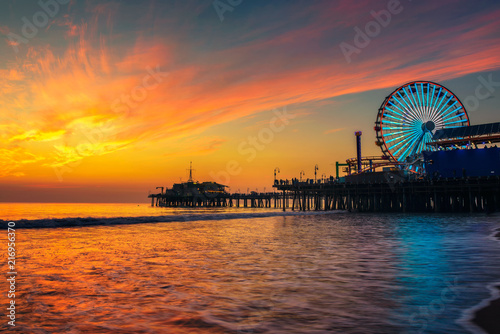 Visitors enjoy sunset above Santa Monica Pier in Los Angeles photo