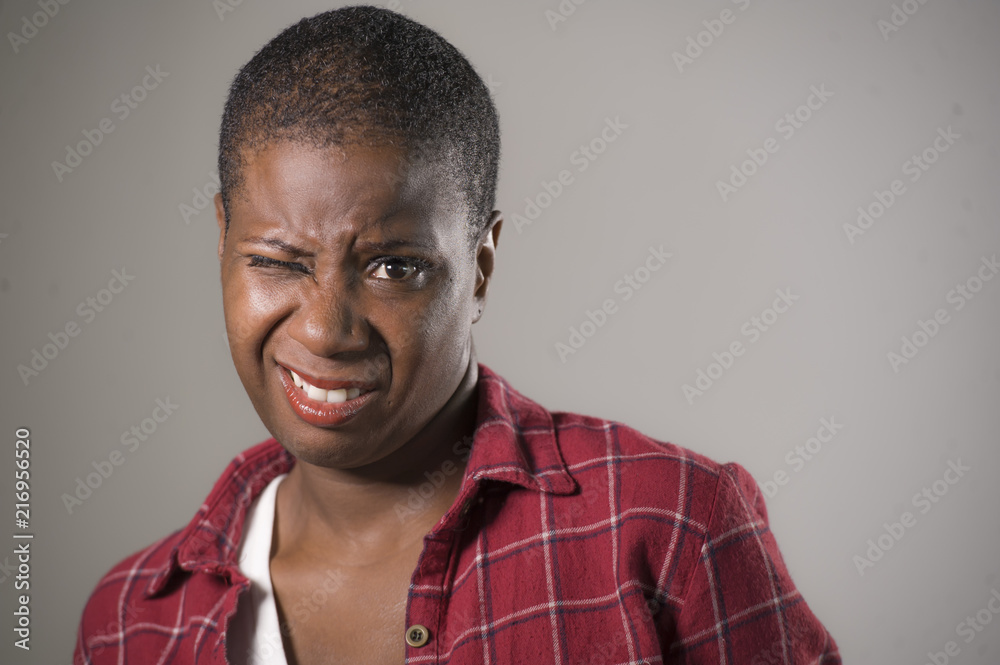 lifestyle portrait if young unhappy and pretty african American woman in contempt and disgust face expression as if disliking or finding disgusting lifestyle portrait if young unhappy and pretty african American woman in contempt and disgust face expression as if disliking or finding disgusting