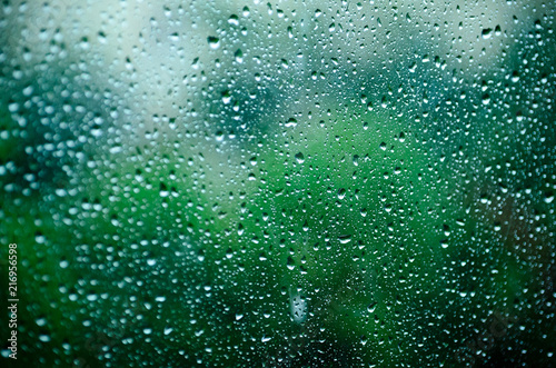 Drops of water on the glass, window. Rainy weather in the summer.