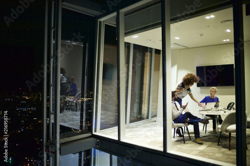 Executives in a corporate office working late