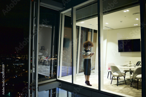 Executive woman working alone in office at night