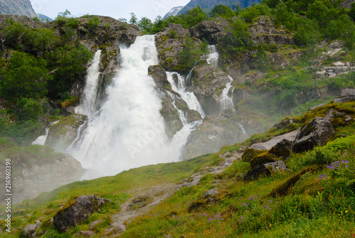 Picturesque waterfall with water melted from Jostedalsbreen Glacier, the biggest glacier in continental Europe located in Sogn og Fjordane county, Norway.
