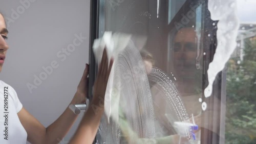 Two Young Women Washing Office Window