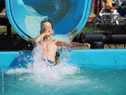 Little boy playing in a water park © Zdenk