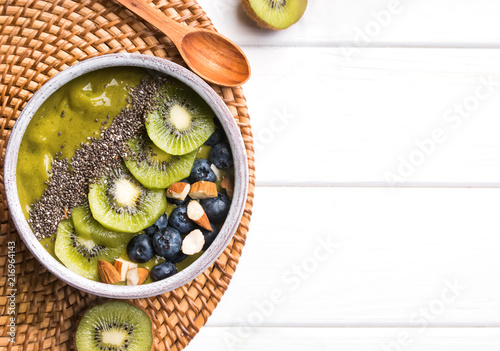 Green smoothie bowl with kiwi, blueberry and chia seeds photo