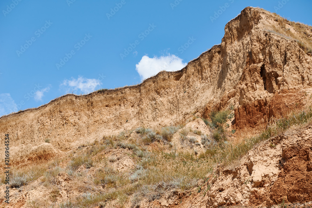 beautiful sea summer landscape, wild beach closeup, sea coast with high hills and cloudy sky beautiful sea summer landscape, wild beach closeup, sea coast with high hills and cloudy sky