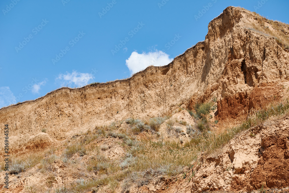 beautiful sea summer landscape, wild beach closeup, sea coast with high hills and cloudy sky