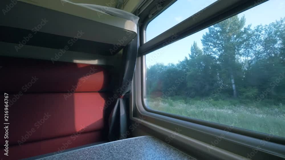 Side view of an interior of a coupe coach in a moving train. Travelling by train concept. Side view of an interior of a coupe coach in a moving train. Travelling by train concept.