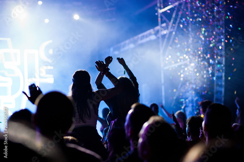 cheering crowd with raised hands at concert - music festival