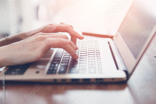 business girl closeup hand typing on modern thin and light computer laptop kayboard