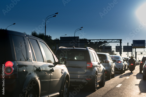 Traffic jam on a hot summer evening. Highway and road junction. Sunset and cars
