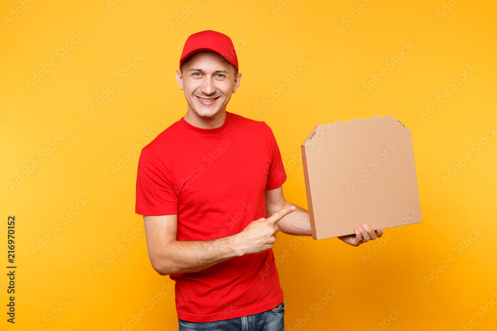 Delivery man in red cap, t-shirt giving food order pizza boxes isolated on yellow background. Male employee pizzaman courier holding pizza in empty blank cardboard flatbox copy space. Service concept. Delivery man in red cap, t-shirt giving food order pizza boxes isolated on yellow background. Male employee pizzaman courier holding pizza in empty blank cardboard flatbox copy space. Service concept.