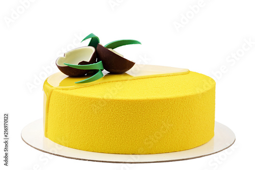 Yellow tropical mousse cake isolated on white