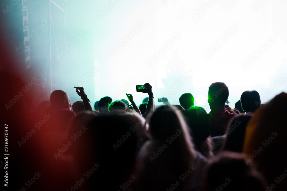 cheering crowd with raised hands at concert - music festival