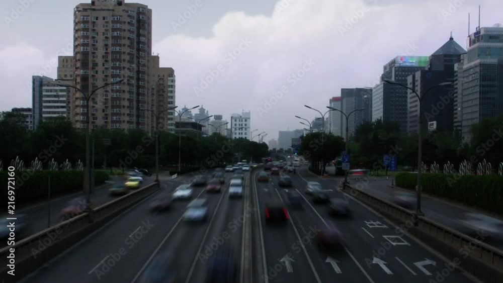 Timelapse tilt down day to night of traffic and apartment buildings in Beijing China Timelapse tilt down day to night of traffic and apartment buildings in Beijing China