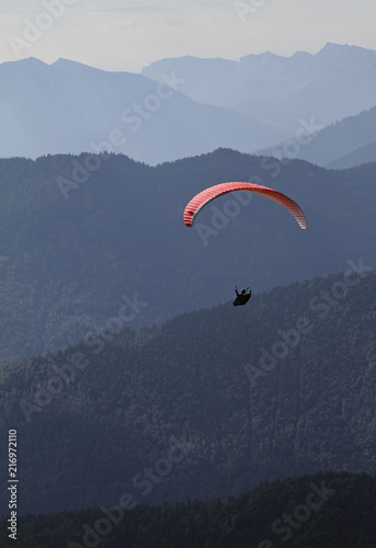 Paraglider in front of alpine mountain range