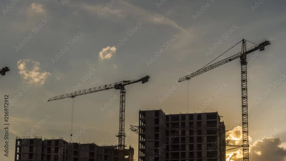 Cranes working day and night on construction of the housing estate in former industrial zone, time lapse Cranes working day and night on construction of the housing estate in former industrial zone, time lapse