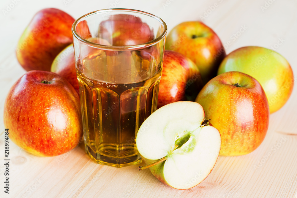 Glass of fresh apple cider and half apple near autumn apples. Glass of fresh apple cider and half apple near autumn apples.