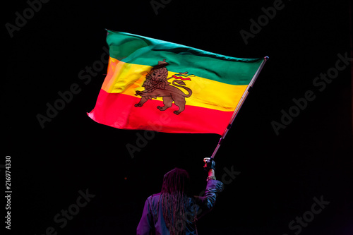 black man waving jamaica flag