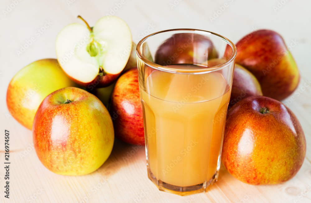 Glass of fresh apple juice and half apple near autumn apples. Glass of fresh apple juice and half apple near autumn apples.