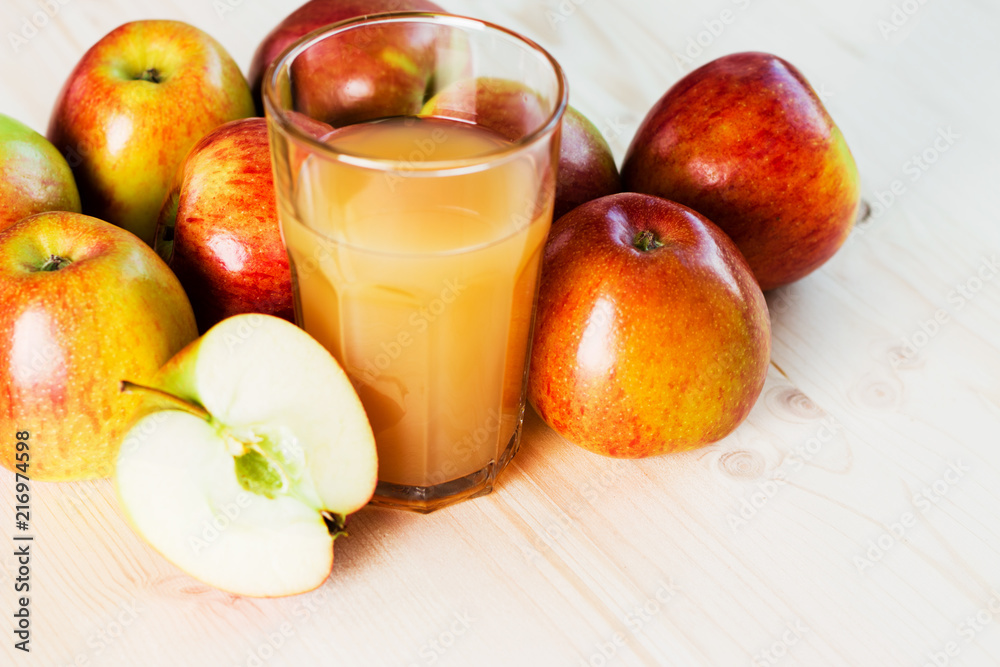Glass of fresh apple cider and half apple near autumn apples. Glass of fresh apple cider and half apple near autumn apples.
