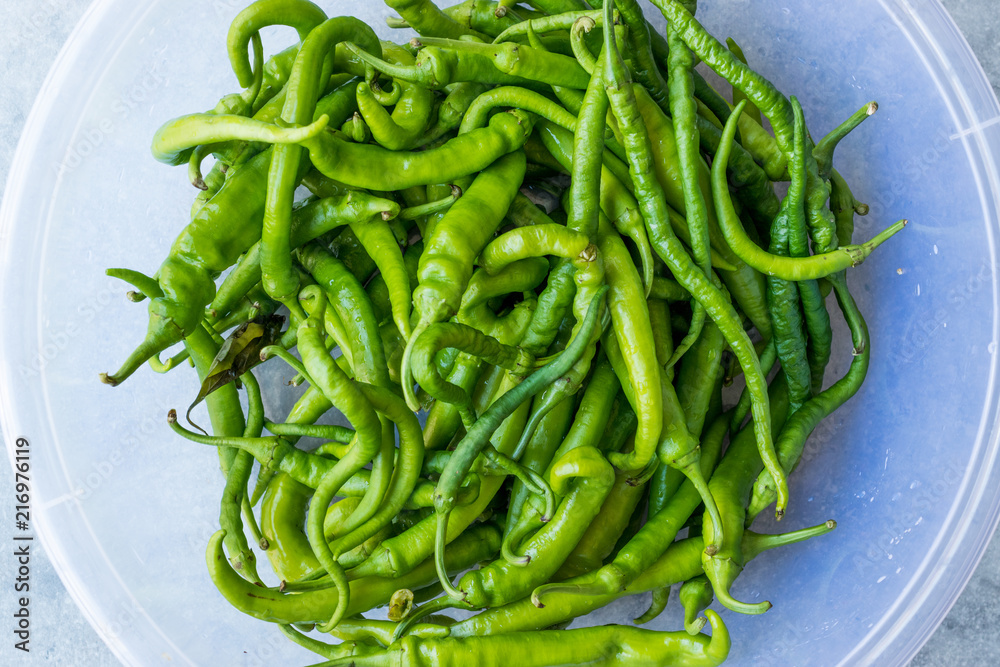 Green Chili Peppers in Transparent Plastic Bowl.