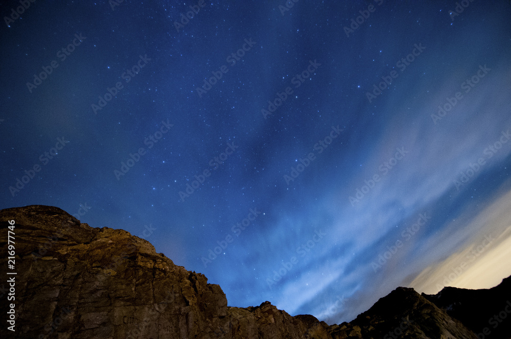 night view with stars and blue sky over the mountains