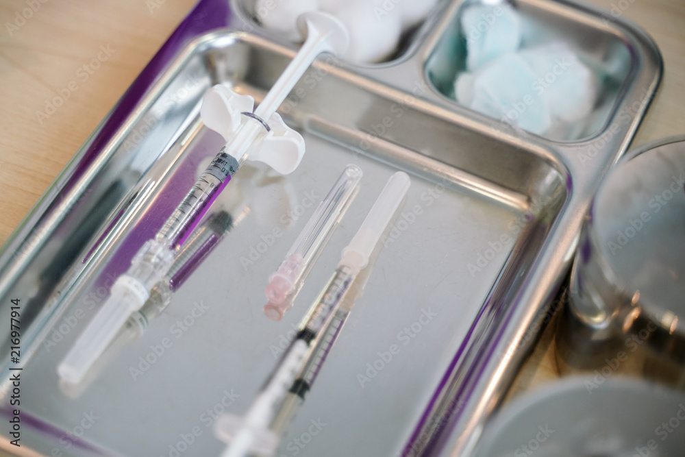 Syringe with needle on a steel tray for a medical vaccine in a hospital Syringe with needle on a steel tray for a medical vaccine in a hospital