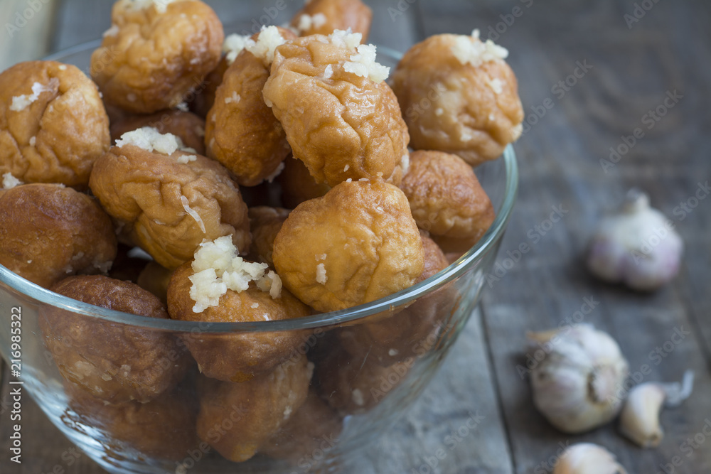 Donuts with garlic on a wooden background.