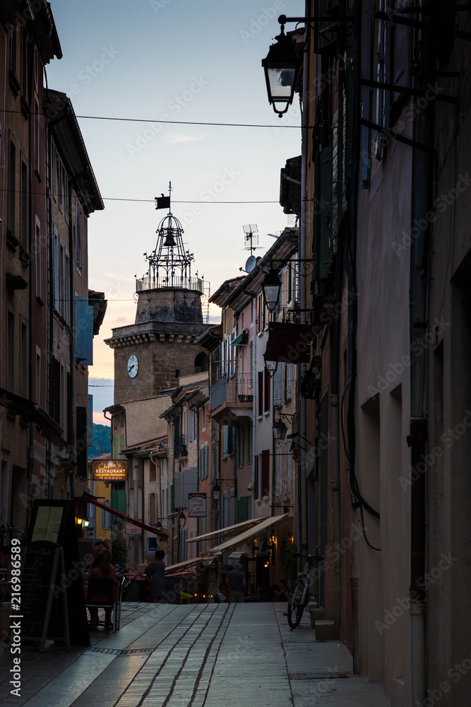 the main street of the charming village of Nyons, Provence, France at sunset.