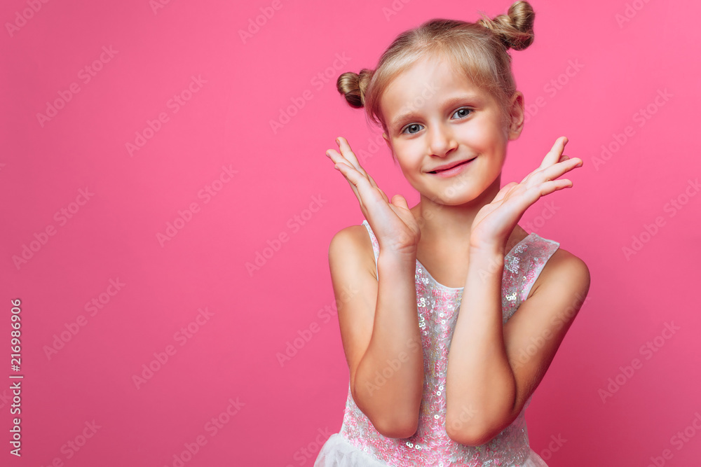 Portrait of a beautiful little girl, on a pink background, in a photo Studio, close-up Portrait of a beautiful little girl, on a pink background, in a photo Studio, close-up