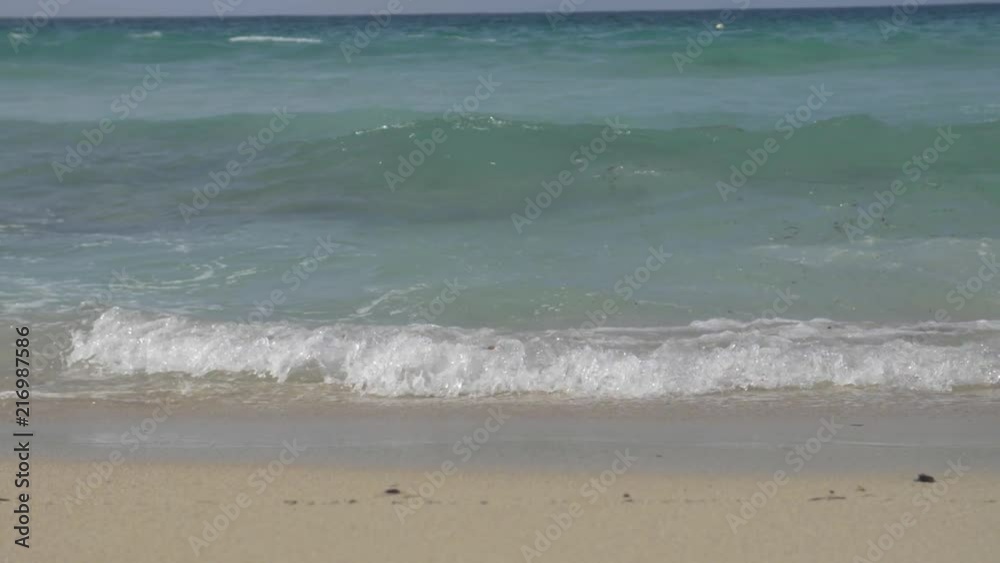 Waves hitting the shore of a sandy beach at 180fps slow motion Waves hitting the shore of a sandy beach at 180fps slow motion