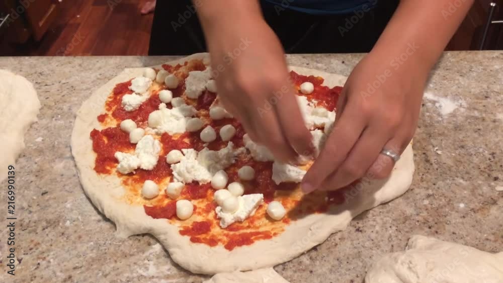 Placing cheese on pizza Placing cheese on pizza