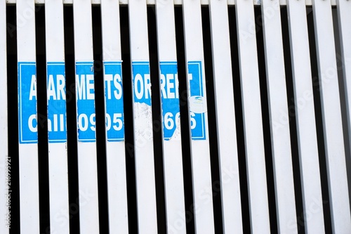 Remnants of For Rent sign in blue and white