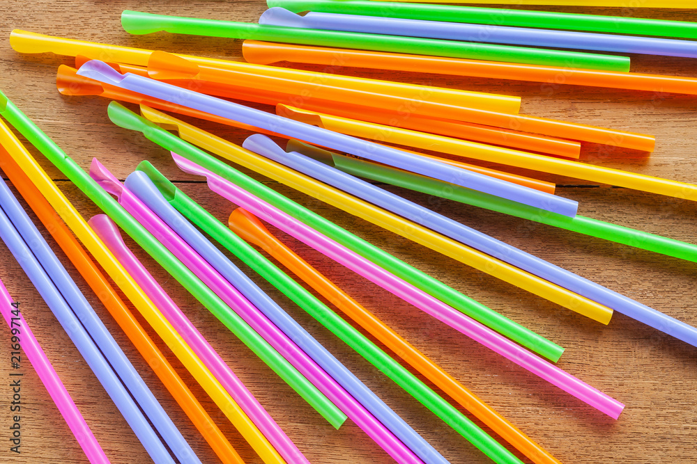 Colorful Straw on wood table background.