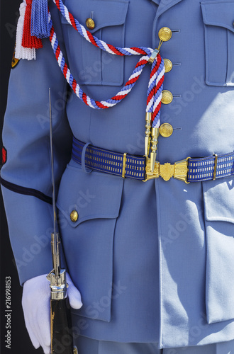 Close up of guard of honour soldier in ceremonial uniform and white dress gloves holding rifle with bayonet