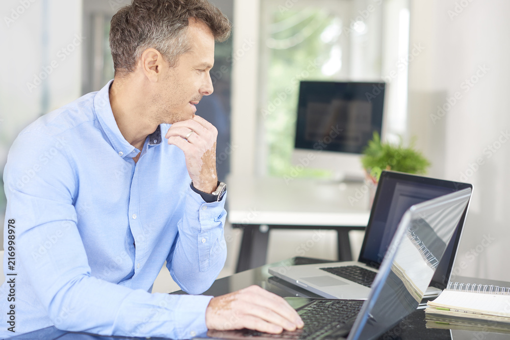 Businessman using laptops in the office Businessman using laptops in the office