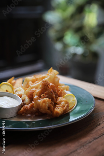 Canvas Print Fish and chips fried fish and potatoes on wood background vintage style