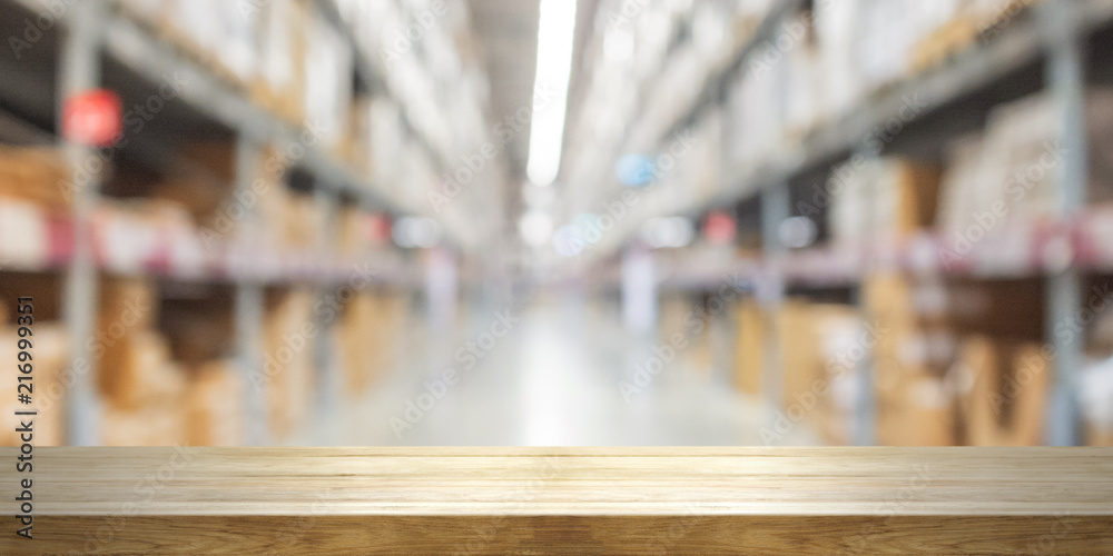 Empty wooden table top with blurred store background. Empty wooden table top with blurred store background.