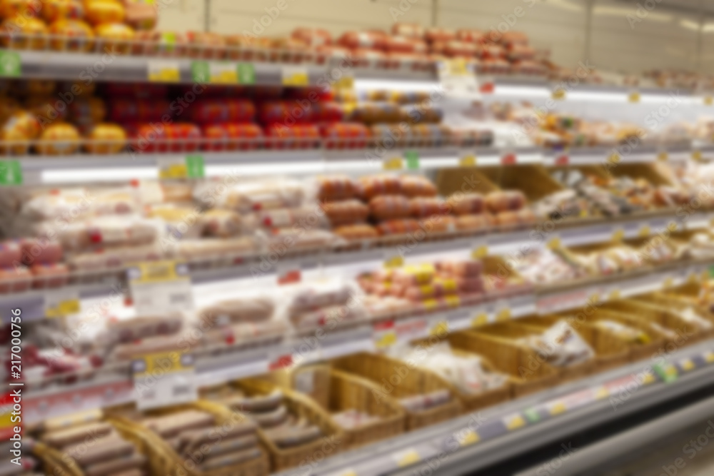Fototapeta premium Blurred photos showcases shops. Long rows of racks with goods.