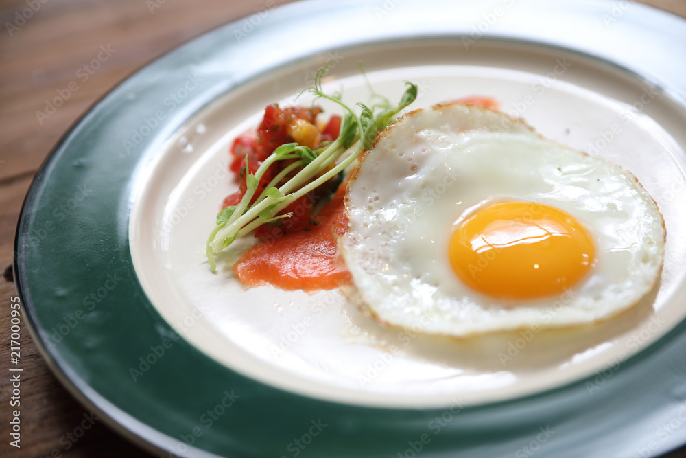 Zucchini fritters with egg and smoked salmon on wood background vinage style Zucchini fritters with egg and smoked salmon on wood background vinage style