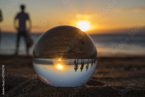 Sunset at Beach with Glass Ball and Silhouette