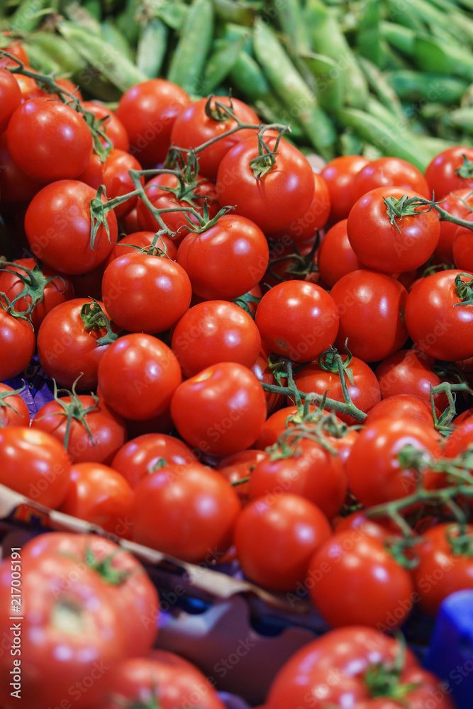 Fresh tomatoes on the counter of a street market or a supermarket or a store. 