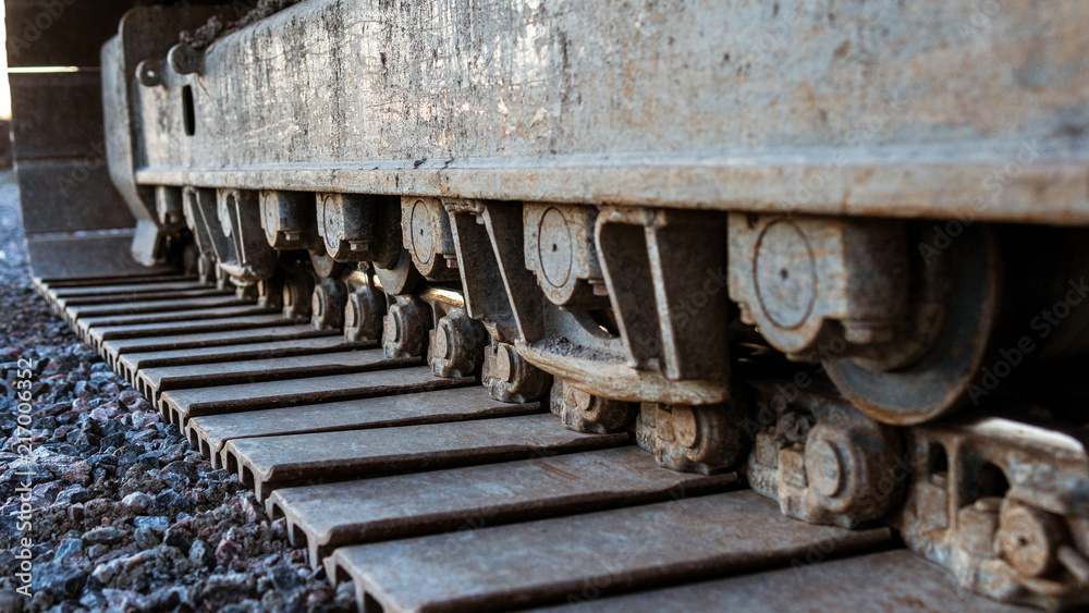 Continuous tracks on a backhoe loader. Continuous tracks on a backhoe loader.