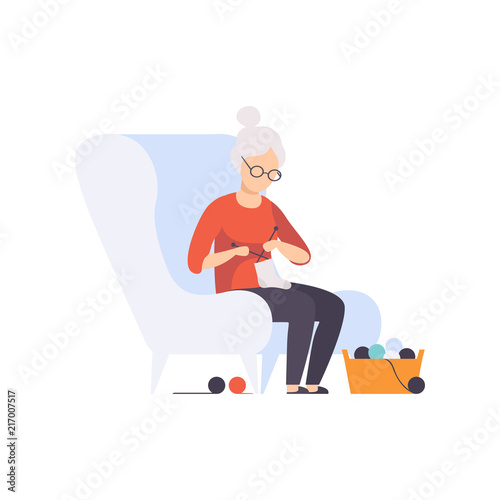Senior woman character sitting in armchair and knitting, elderly people leading an active lifestyle social concept vector Illustration on a white background