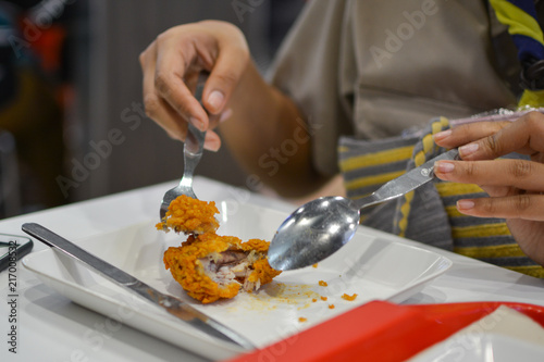 Knife cutting fried chicken on the plate