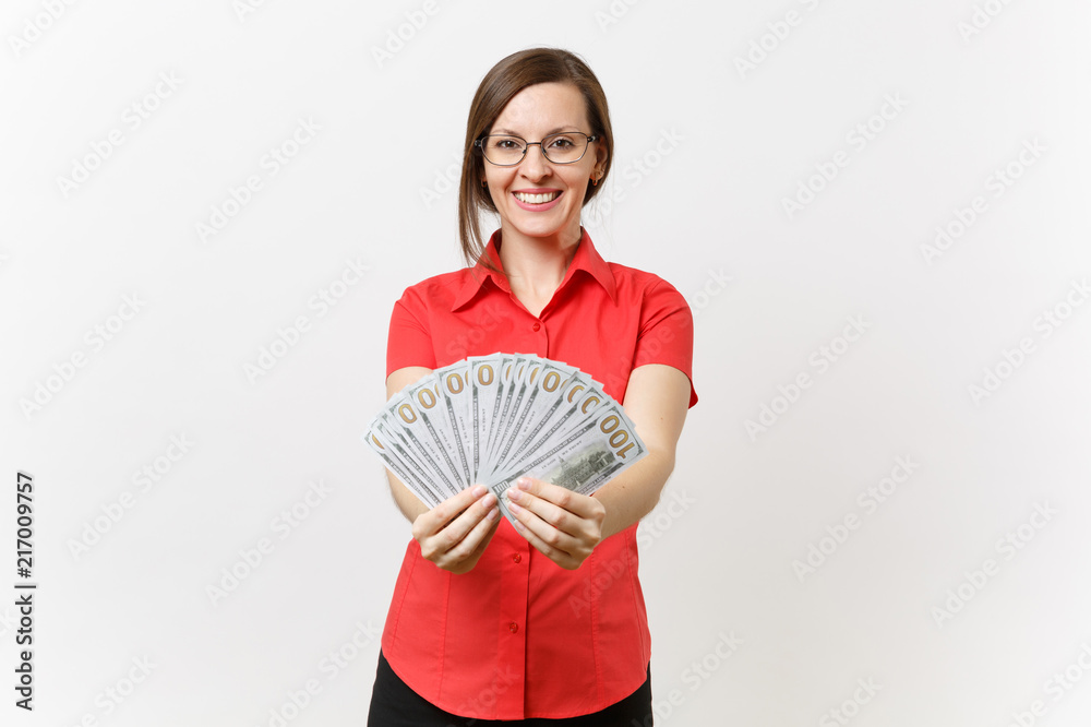 Portrait of pretty young business teacher woman in red shirt skirt glasses holding bundle lots of dollars, cash money isolated on white background. Education teaching in high school university concept Portrait of pretty young business teacher woman in red shirt skirt glasses holding bundle lots of dollars, cash money isolated on white background. Education teaching in high school university concept